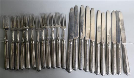 A part matched set of George III silver fruit eaters (11 knives and 12 forks)